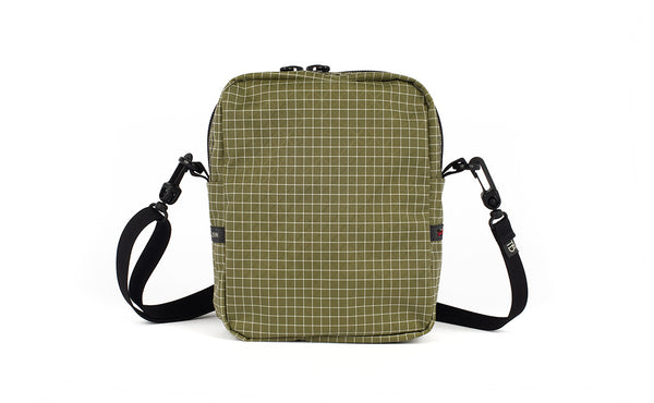 A back view of the Everyday Cubelet in Taiga Halcyon (olive green with a white grid) showing a completely fabric back.